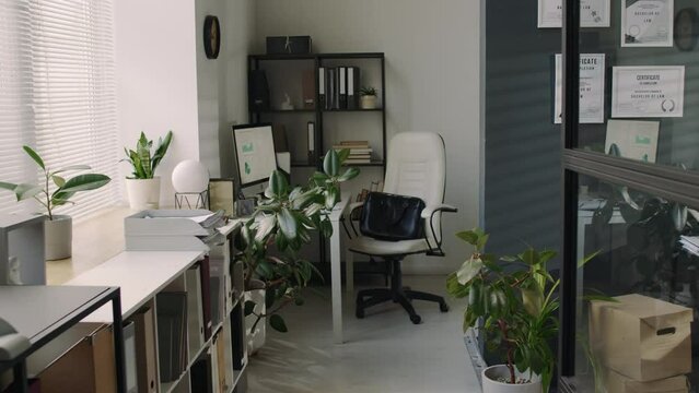 No people pull out footage of empty workplace with table and computer monitor with graphics on screen in modern loft office in law firm