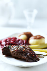 Beef steak with potato dumplings on bright background. Close up. Copy space.