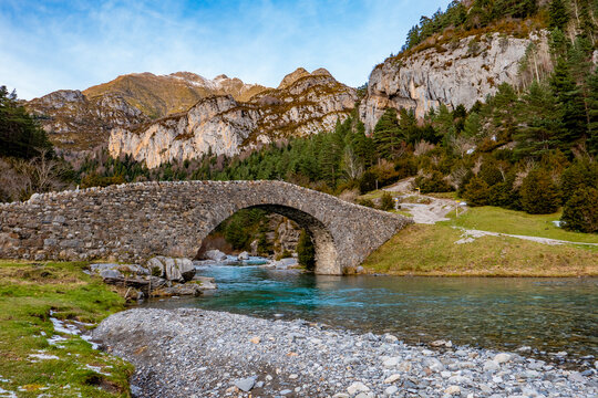 Torla-Ordesa, Huesca, Arag&oacute;n, Spain - December 6, 2023: Romanesque bridge of San Nicolas de Bujaruelo over the River Ara in Ordesa - Monte Perdido National Park