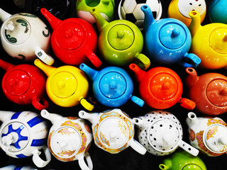 Beautiful multicolored oriental-style teapots are on sale at the market. An oriental ceramics...
