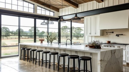 a modern farmhouse kitchen boasting an island, marble benchtops, and sleek black barstools, paired with pristine white cabinets and expansive windows offering panoramic views of the countryside.