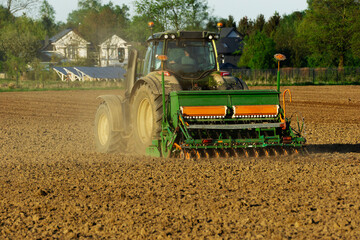 Tractor with a seeder in the field.