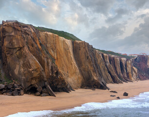 Sandy beach Praia do Guincho (Santa Cruz, Portugal). Misty weather.