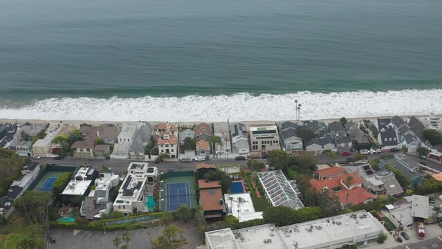 Sideways shot of Malibu Beach suburban homes right next to Pacific Ocean beach
