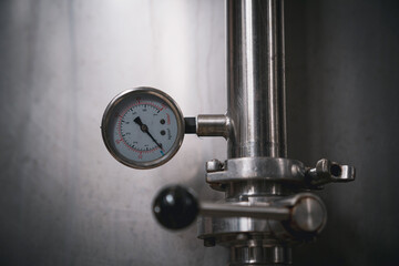 Close-up view of a pressure gauge for measuring and controlling pressure in instruments.