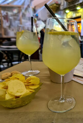 Typical italian aperitif (aperitivo) served with potato chips at bar in Naples, Campania, Italy,...