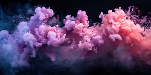 Fototapeta premium magenta and pink fluffy pastel ink smoke cloud against black background