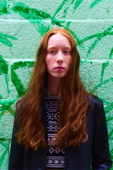 Beautiful young woman, natural red hair with black leather jacket