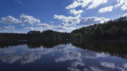 Blue tonal landscape with clouds reflected in water