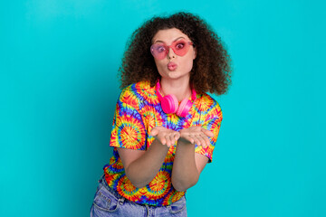 Photo of cute adorable positive girl wear stylish print clothes send kiss isolated on cyan color background