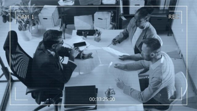 Overhead CCTV camera footage of senior barrister consulting diverse female and male customers and helping them make up bargain and sale agreement during workday in modern office
