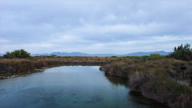 Place where water is born in the desert between mountains and grasslands or also known as Poza Azul Coahuila Mexico Strate traking camera movement drone