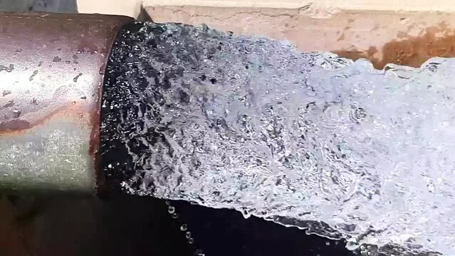 Tube Well Water. Water is coming out from a Tube Well. Irrigation water flow from pipe for agriculture fields. slow motion water flash. Beautiful 4k footage.