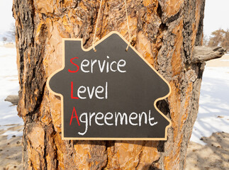 SLA service level agreement symbol. Concept words SLA service level agreement on beautiful yellow...