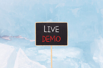 Live demo symbol. Concept words Live demo on beautiful yellow black blackboard. Beautiful blue ice...