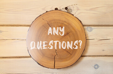 Any questions symbol. Concept words Any questions on beautiful wooden circle. Beautiful wooden wall...