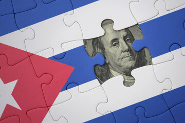 puzzle with the national flag of cuba and usa dollar banknote. finance concept