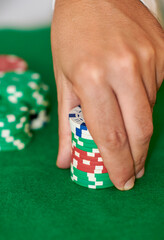 Closeup of hands betting chips in casino