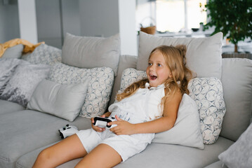 Young girl playing video games at home