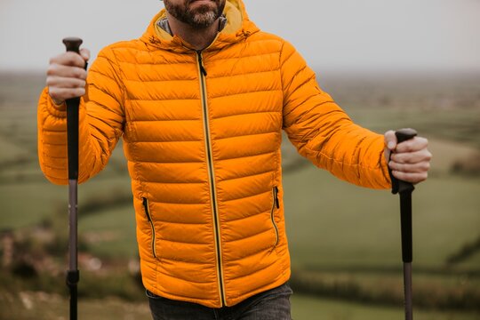 Man wearing orange puffer jacket, outdoor outfits