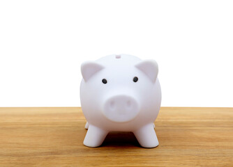 Piggy bank in front view on a wooden table. Copy space.