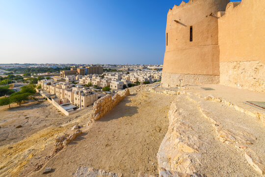 The cliffside, historic Riffa Fort also known as Shaikh Salman bin Ahmed Fateh Fort or Qal'at ar-Riffa, rises above ancient ruins and the town of Riffa, in the Bahraini desert.