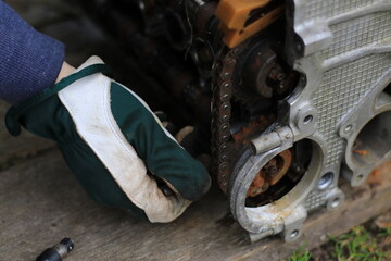 mechanic repairing old broken engine