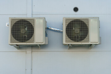 Outdoor air conditioning unit. A large modern air conditioner on the wall of an apartment building. Repair and maintenance of the air conditioning system