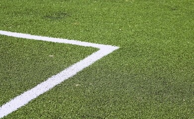 Obraz premium corner of an artificial turf green with a white line football field