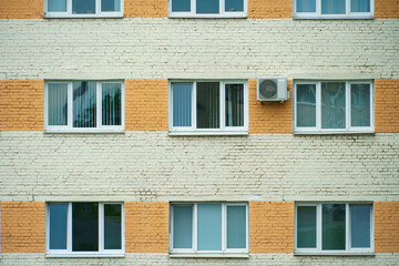 Outdoor air conditioning unit. A large modern air conditioner on the wall of an apartment building....