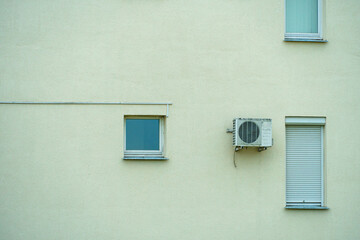 Outdoor air conditioning unit. A large modern air conditioner on the wall of an apartment building....