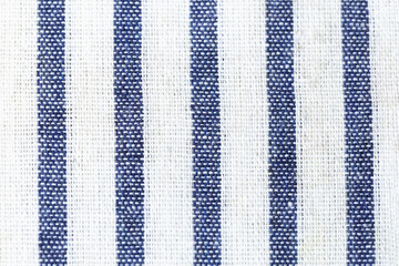 Texture of a blue and white striped fabric. The stripes are vertical and the background is white