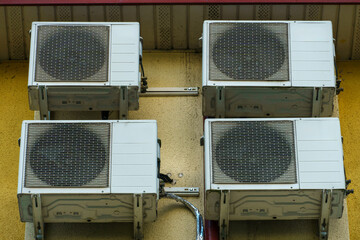Outdoor air conditioning unit. A large modern air conditioner on the wall of an apartment building....