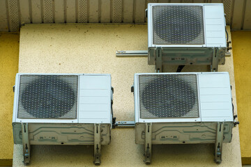 Outdoor air conditioning unit. A large modern air conditioner on the wall of an apartment building....