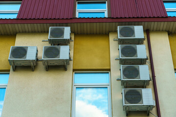 Outdoor air conditioning unit. A large modern air conditioner on the wall of an apartment building....