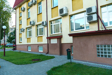 Outdoor air conditioning unit. A large modern air conditioner on the wall of an apartment building....