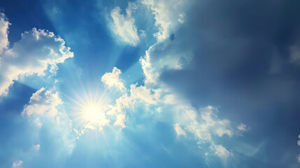 Amazing white fluffy clouds moving softly on bright blue sky with rays of the rising sun
