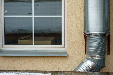 Ventilation pipes on the facade of the building. Metal pipes covered with a thermal shell in the...