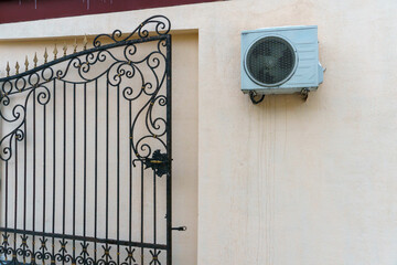 Outdoor air conditioning unit. A large modern air conditioner on the wall of an apartment building. Repair and maintenance of the air conditioning system