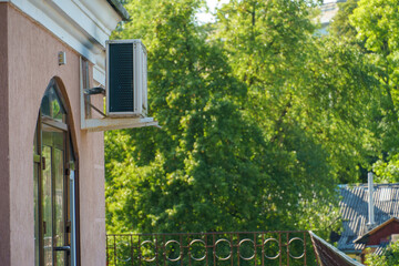 Outdoor air conditioning unit. A large modern air conditioner on the wall of an apartment building....