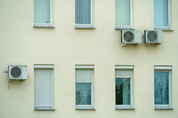 Outdoor air conditioning unit. A large modern air conditioner on the wall of an apartment building....