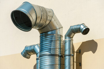 Ventilation pipes on the facade of the building. Metal pipes covered with a thermal shell in the...