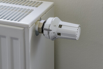 Close-up white radiator heater thermostat turned to maximum.