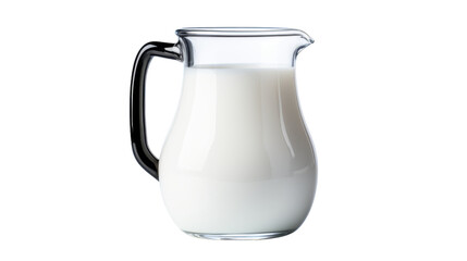 Glass pitcher filled with milk stands on a table
