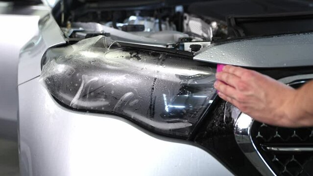 Gluing PPF film on a car with the steam for protection of the car surface against mechanical abrasion, UV, IV and road contamination