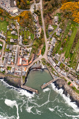 Aerial landscape view directly above Craster Harbour and village in Northumberland