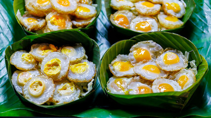fried Quail eggs on banana leave in thai street food market