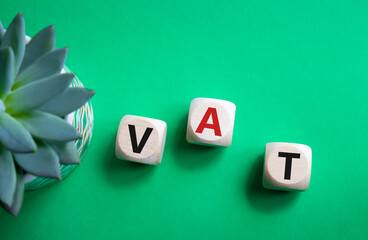 VAT - Value Added Tax symbol. Wooden cubes with word VAT. Beautiful green background with succulent plant. Business and Value Added Tax concept. Copy space. - obrazy, fototapety, plakaty