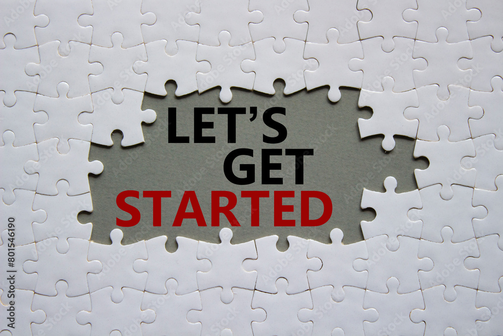 Wall mural lets get started symbol. concept words lets get started on white puzzle. beautiful grey background. 