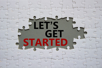 Lets get started symbol. Concept words Lets get started on white puzzle. Beautiful grey background....